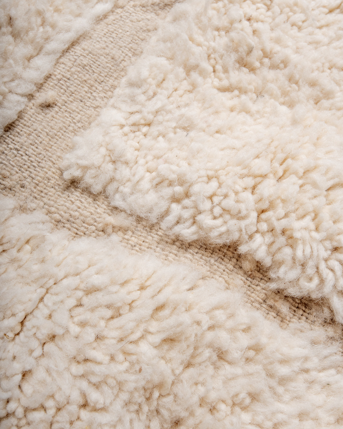 Modern, designer, handcrafted Berber rug from Morocco. Beniourain carpet with minimalist design, natural wool pile and a fluffy texture.